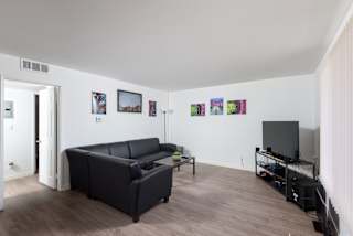 a living room with a leather couch and a tv