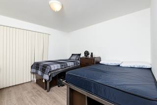 a bedroom with two beds and a large window