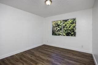 an empty room with white walls and a window