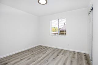 an empty room with white walls and a window