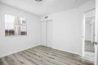 an empty room with white walls and a window