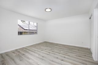 an empty room with white walls and a window