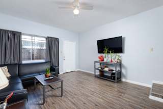 a living room with a leather couch and a tv