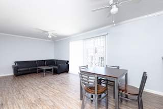 an empty living room with a dining room table and couch