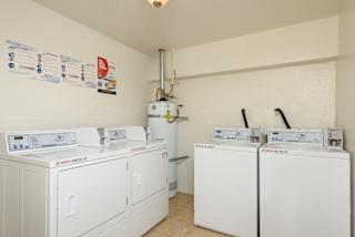 the laundry room is equipped with four washes and dryers
