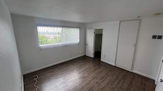 A room with a window and a door.