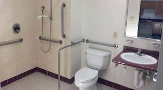 A bathroom with a toilet, sink, and shower.