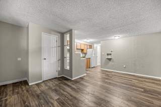 A room with wooden floors and white walls.