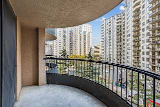 the balcony of a condo with a view of the city