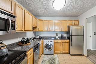 a kitchen with stainless steel appliances and wooden cabinets
