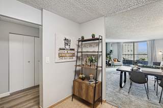 an open living room and dining room with a table and chairs and a large window