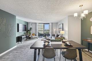 an open living room and dining room with a table and chairs