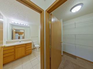 A bathroom with a sink, toilet, and a mirror.