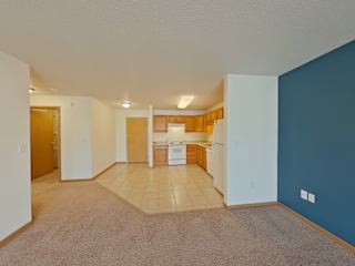 A kitchen area with a dining table and chairs.