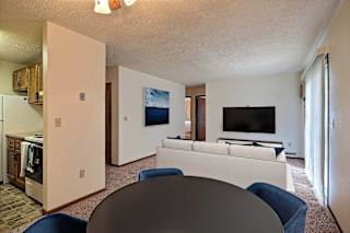 a living room with a couch and a table. Fargo, ND Pacific South Apartments
