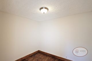 A room with hardwood flooring and white walls.