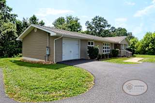 A grey home with an attached garage.