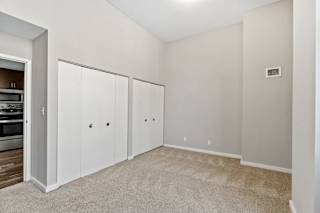 Room with a carpeted floor and a wall-mounted air vent at The Cosmopolitan, St Paul, MN, Minnesota, 55101