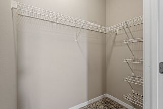 Empty white shelves in a white closet.