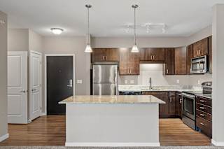 A modern kitchen with a large island in the center.