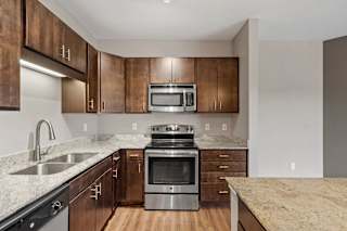 A kitchen with wooden cabinets and stainless steel appliances.