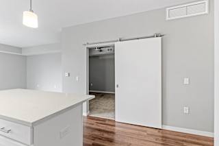 A white kitchen with a sliding door at Galante at Parkside in Apple Valley, MN