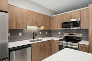 A kitchen with wooden cabinets and stainless steel appliances.