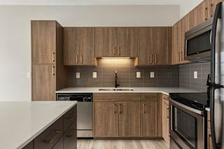 A kitchen with wooden cabinets and stainless steel appliances.