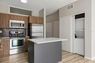 A kitchen with a stove, oven, and refrigerator.