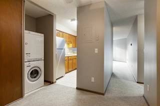 View of washing machine and kitchen from dining room.