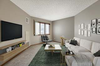 A living room with a white couch and a television.