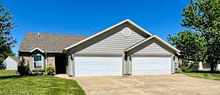 a white garage door in front of a house at Shenandoah Properties in Lafayette, IN 47905