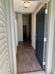 the hallway of a house with a blue door at Shenandoah Properties in Lafayette, IN 47905