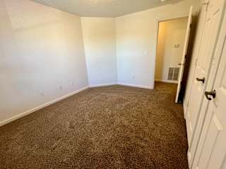an empty room with a carpeted floor and white walls at Shenandoah Properties in Lafayette, IN 47905
