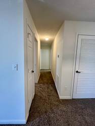 a hallway with a closet and a door to a bedroom at Shenandoah Properties in Lafayette, IN 47905
