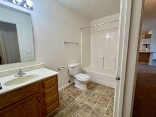 a bathroom with a toilet and a sink and a shower at Shenandoah Properties in Lafayette, IN 47905
