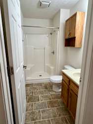 a small bathroom with a toilet and a shower at Shenandoah Properties in Lafayette, IN 47905