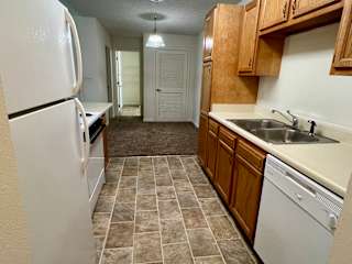 a kitchen with a sink and a refrigerator at Shenandoah Properties in Lafayette, IN 47905