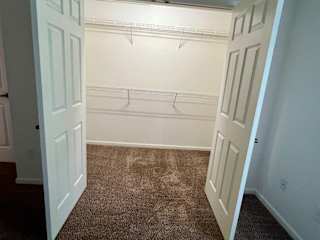 a room with a carpeted floor and a closet at Shenandoah Properties in Lafayette, IN 47905