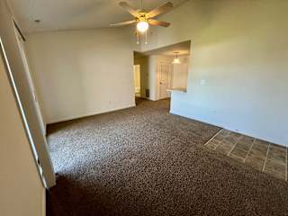 an empty living room with carpet and a ceiling fan at Shenandoah Properties in Lafayette, IN 47905