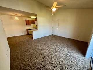 an empty living room with carpeting and a ceiling fan at Shenandoah Properties in Lafayette, IN 47905