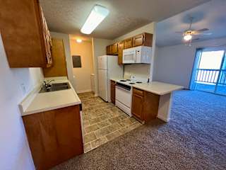 an empty kitchen with a sink and a refrigerator at Shenandoah Properties in Lafayette, IN 47905