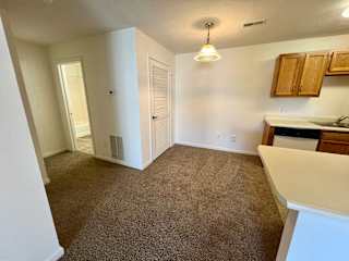 an empty kitchen and dining area in an empty house at Shenandoah Properties in Lafayette, IN 47905