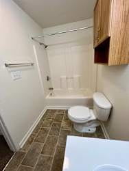 an empty bathroom with a toilet and a bath tub at Shenandoah Properties in Lafayette, IN 47905