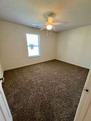 an empty room with carpet and a ceiling fan at Shenandoah Properties in Lafayette, IN 47905