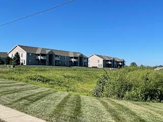 a row of houses on a hill with a blue sky at Hawthorne Properties in Lafayette, IN 47905