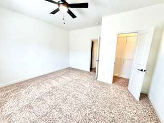 A room with a ceiling fan and carpeted floor.at Concord Crossing, Lafayette, IN