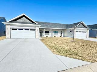A two-car garage is attached to a house.at Concord Crossing, Indiana, 47909