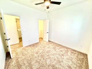 A room with a carpeted floor and a ceiling fan.at Concord Crossing, Lafayette, 47909