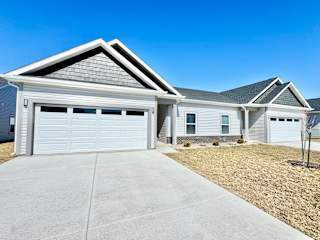 A duplex with a garage is shown.at Concord Crossing, Indiana, 47909
